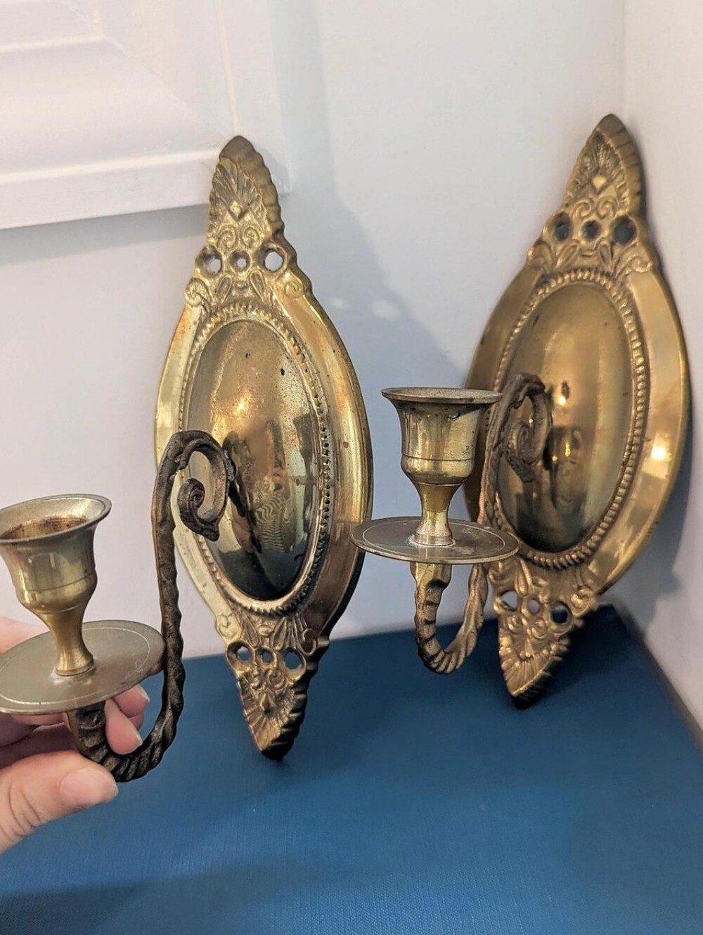 Vintage pair of brass wall sconces with ornate detailing